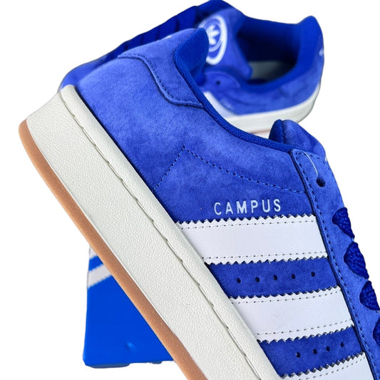 Luxury Chef Adidas Campus royal blue suede sneakers with white stripes and gum sole.