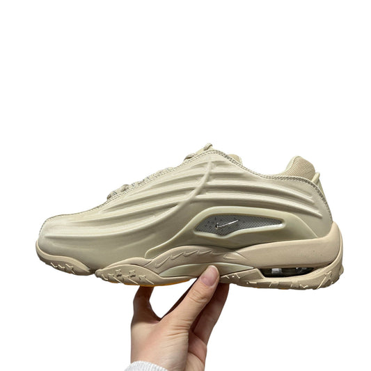 Luxury Chef NOCTA HOT STEP beige sneakers with textured upper and visible air cushioning.