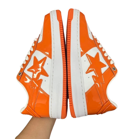 Luxury Chef BAPESTA sneakers in patent orange and white with star detailing. Lace-up closure, white sole.