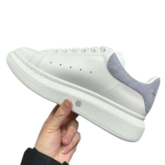 Luxury Chef white leather sneakers with light grey suede heel detail and thick white sole.