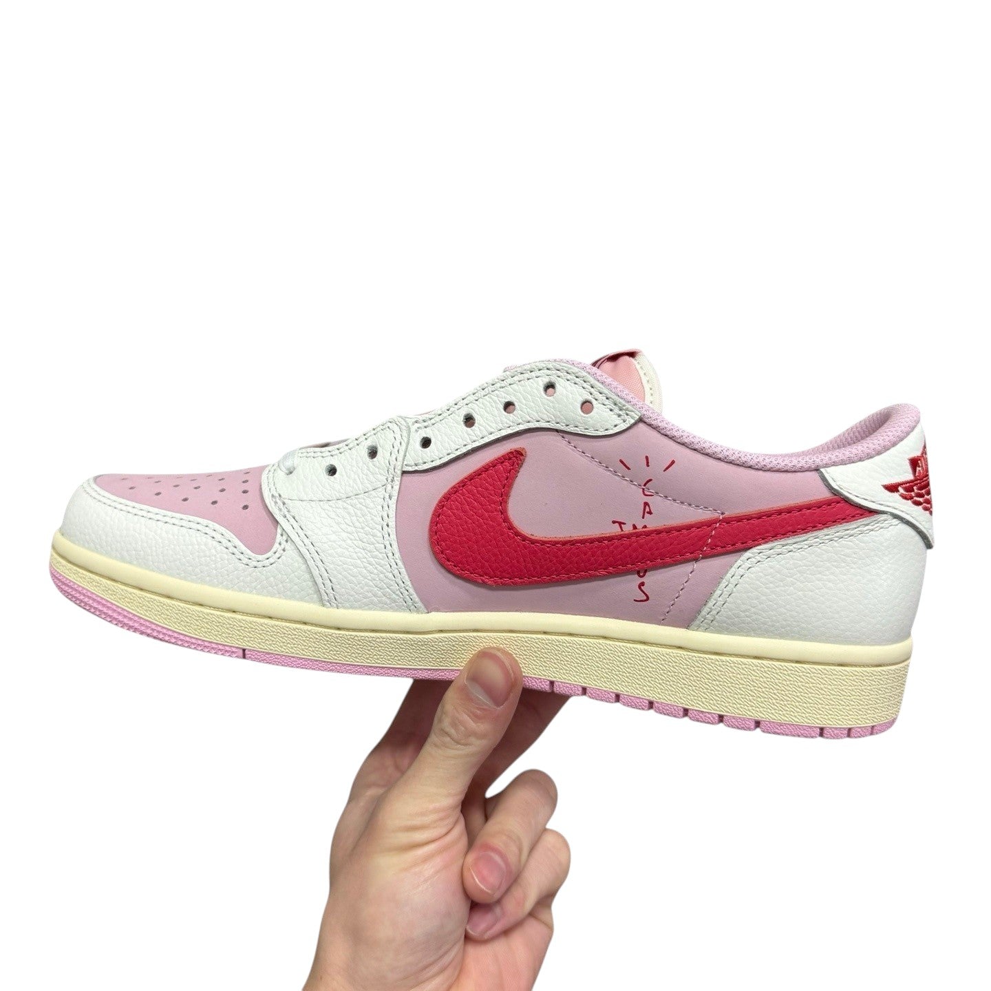 Luxury Chef Air Jordan 1 Low Travis Scott sneakers in pink and white leather with red accents and Cactus Jack branding.
