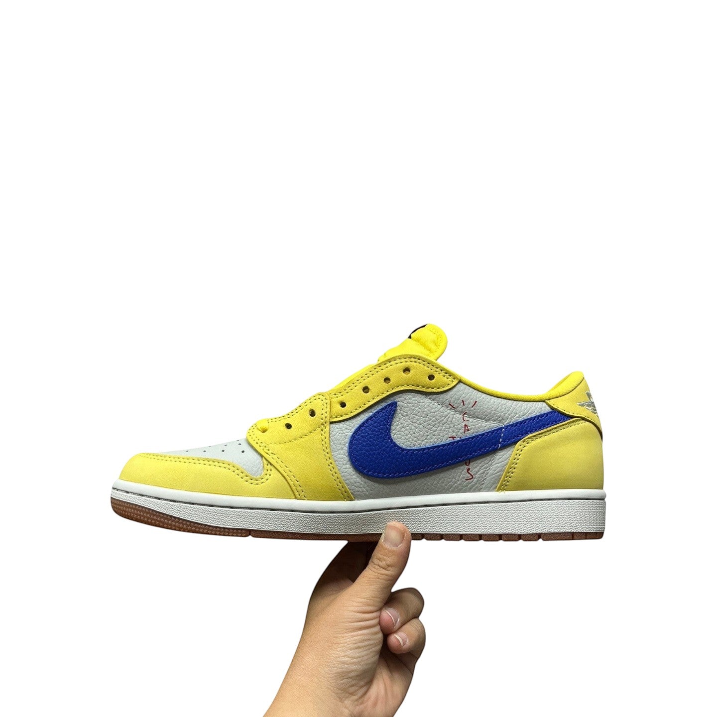 Luxury Chef Air Jordan 1 Low Travis Scott sneakers in yellow, grey, and blue with a gum sole.