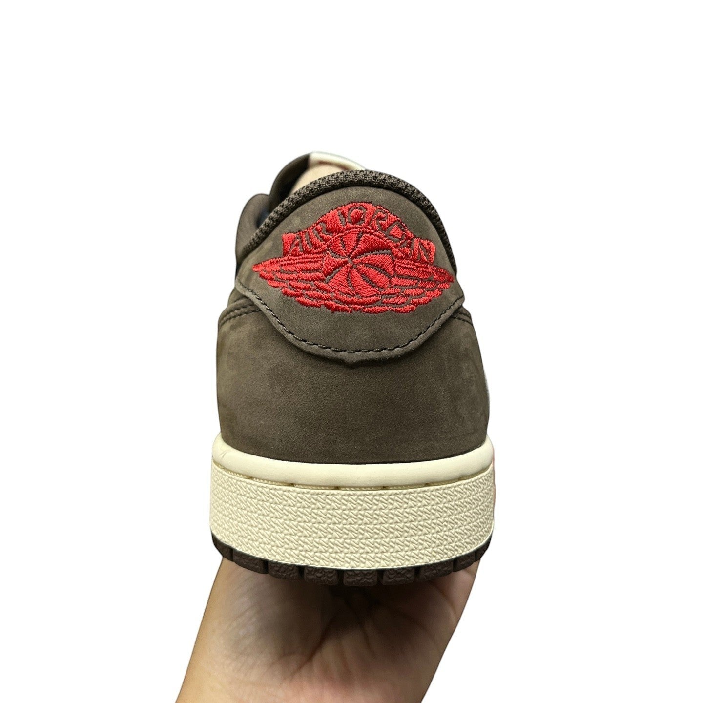 Luxury Chef Air Jordan 1 Travis Scott low-top sneakers in brown suede with red Jumpman logo.