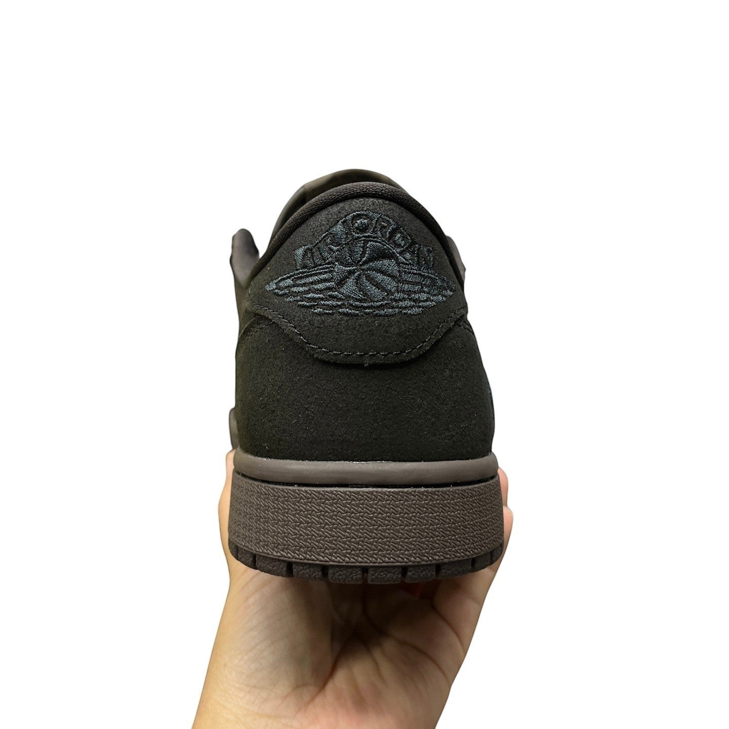 Luxury Chef Air Jordan 1 Travis Scott low-top sneakers in dark brown suede with embroidered Jumpman logo.