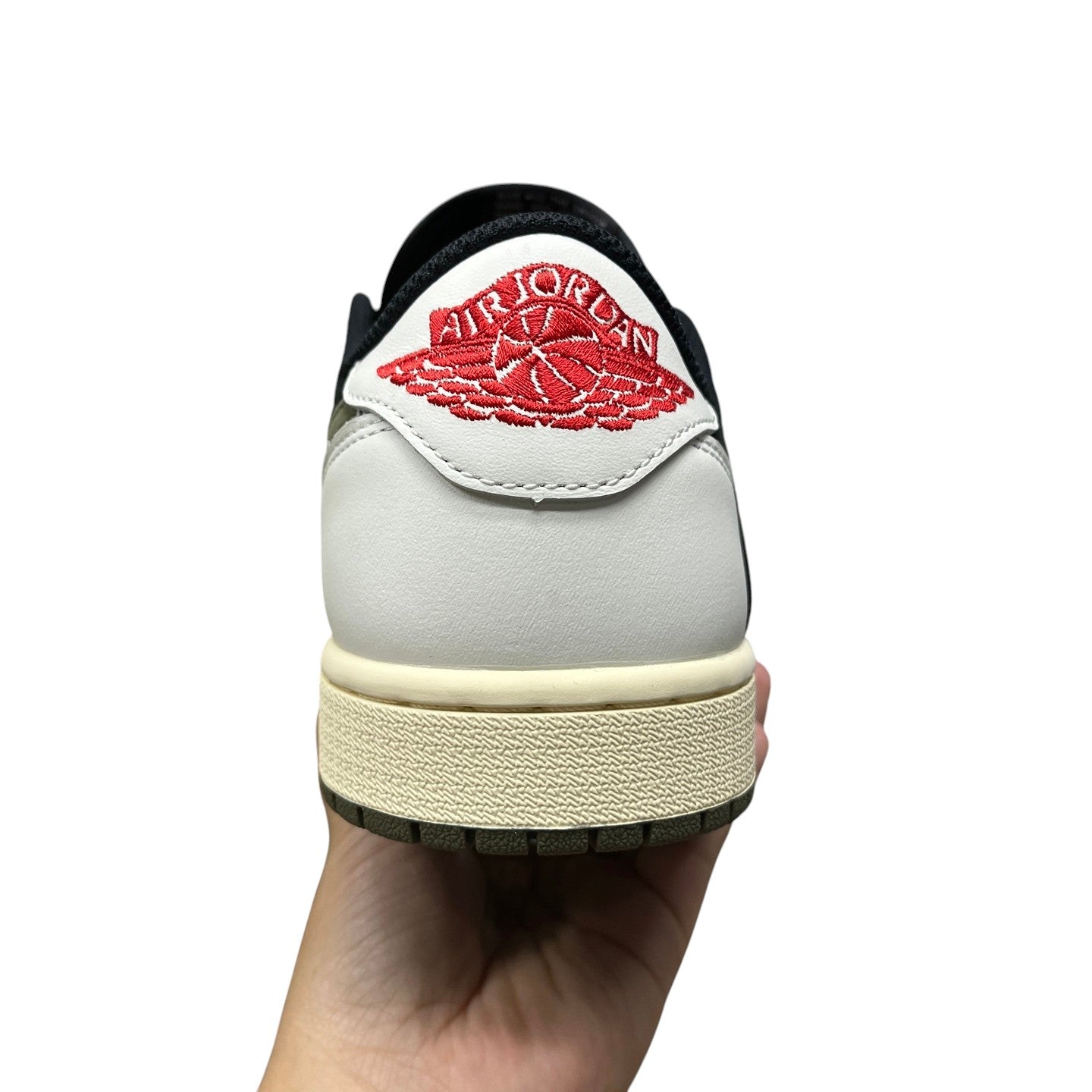 Luxury Chef Air Jordan 1 Travis Scott low-top sneakers in white and black with red Jumpman logo.
