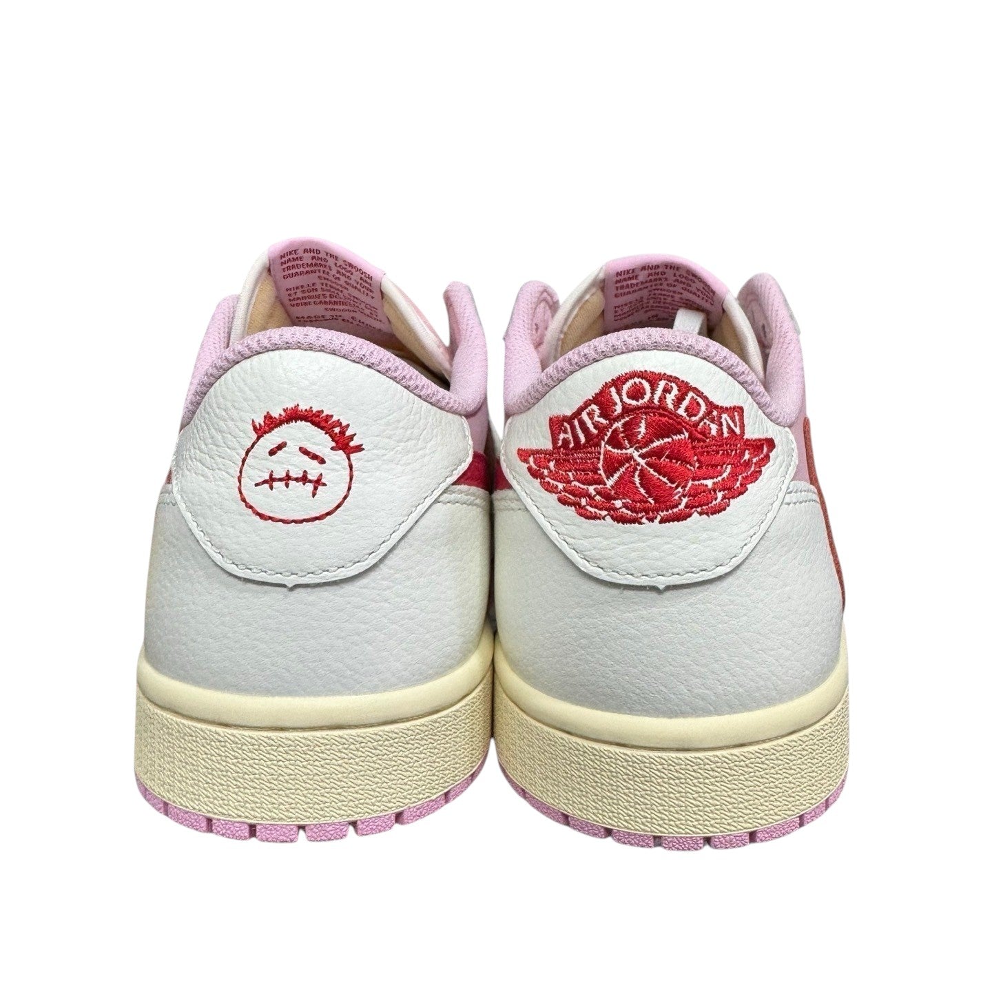 Luxury Chef Air Jordan 1 Travis Scott low-top sneakers in white leather with pink accents and Cactus Jack logo.