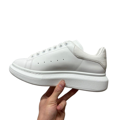 Luxury Chef white leather Alexander McQueen sneakers with crocodile-embossed heel detail and chunky sole.