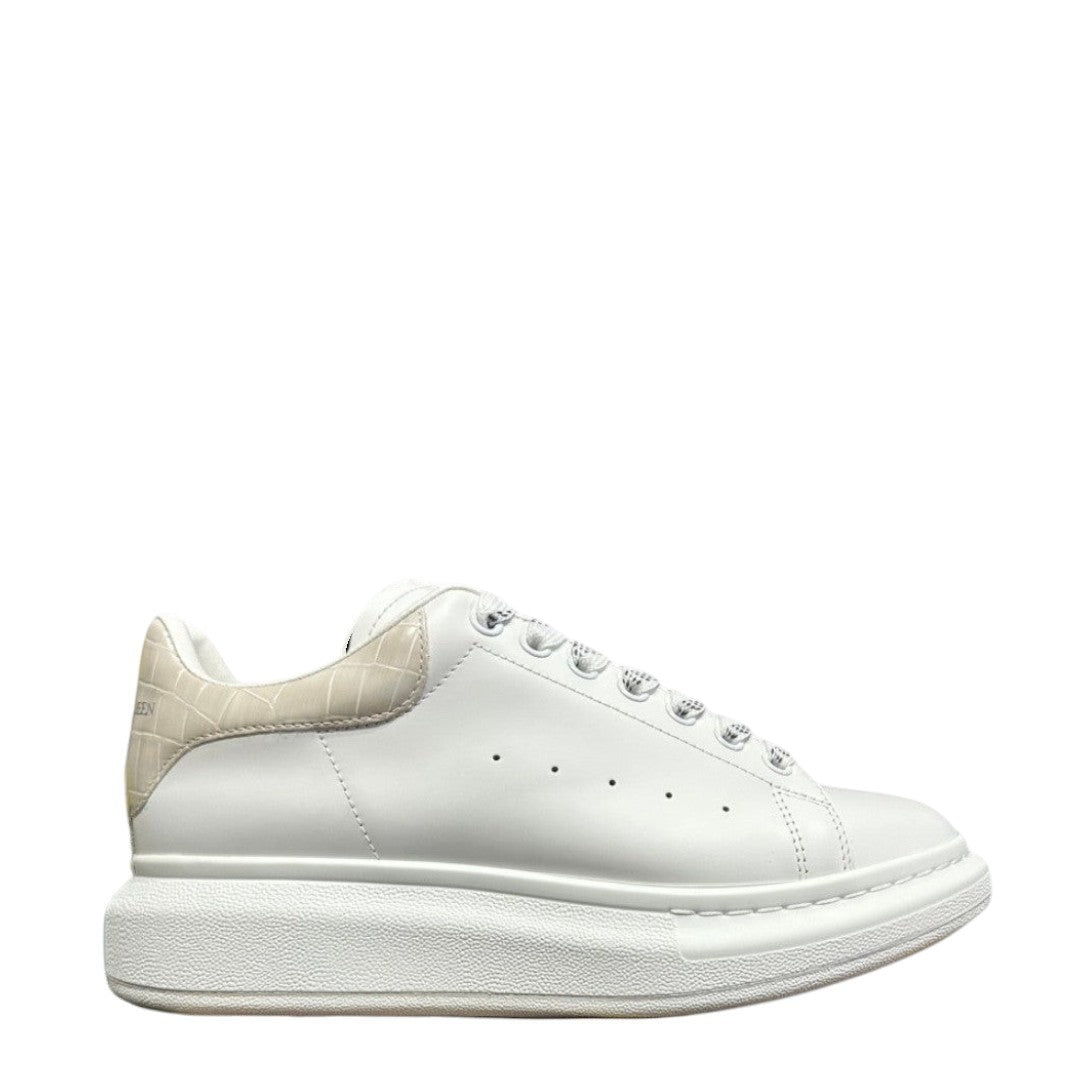Luxury Chef Alexander McQueen white leather sneakers with beige crocodile-embossed heel tab and chunky sole.