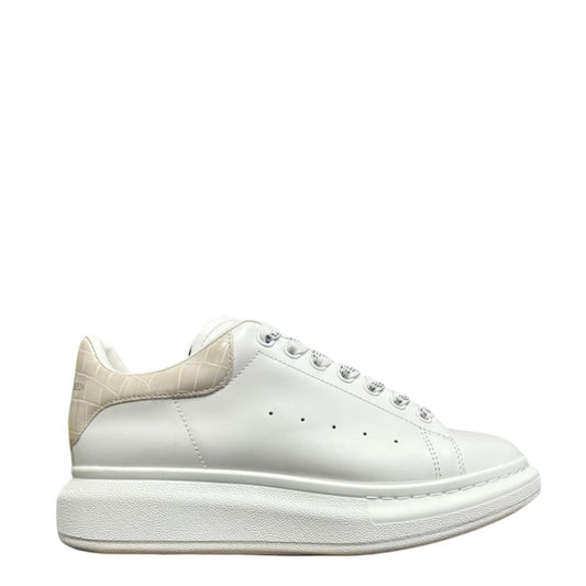 Luxury Chef Alexander McQueen white leather sneakers with beige crocodile-embossed heel tab and chunky sole.