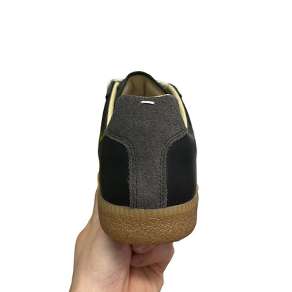 Luxury Chef MAISON MARGIELA black leather sneakers with grey suede heel detail and gum sole.