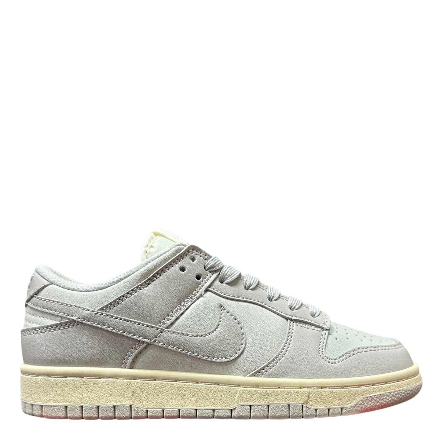 Luxury Chef Nike Dunk Low women's light grey leather sneakers with cream sole and laces.