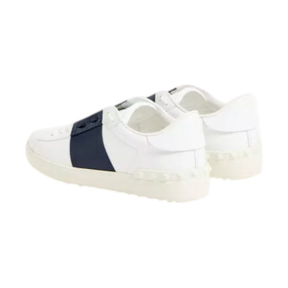 Luxury Chef white leather sneakers with navy blue stripe and signature stud detailing on the sole.