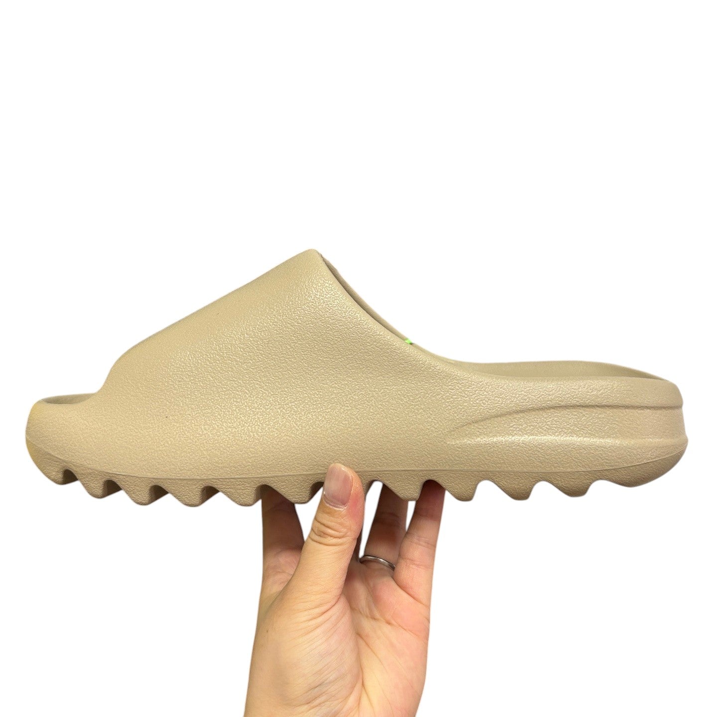Luxury Chef YEEZY SLIDE in a neutral beige, made of EVA foam with a contoured footbed and serrated sole.