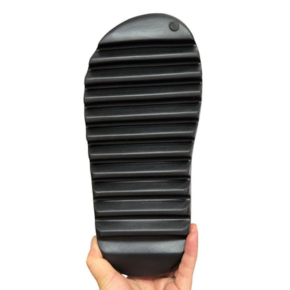 Luxury Chef black YEEZY SLIDE sandal with a thick, ribbed sole.