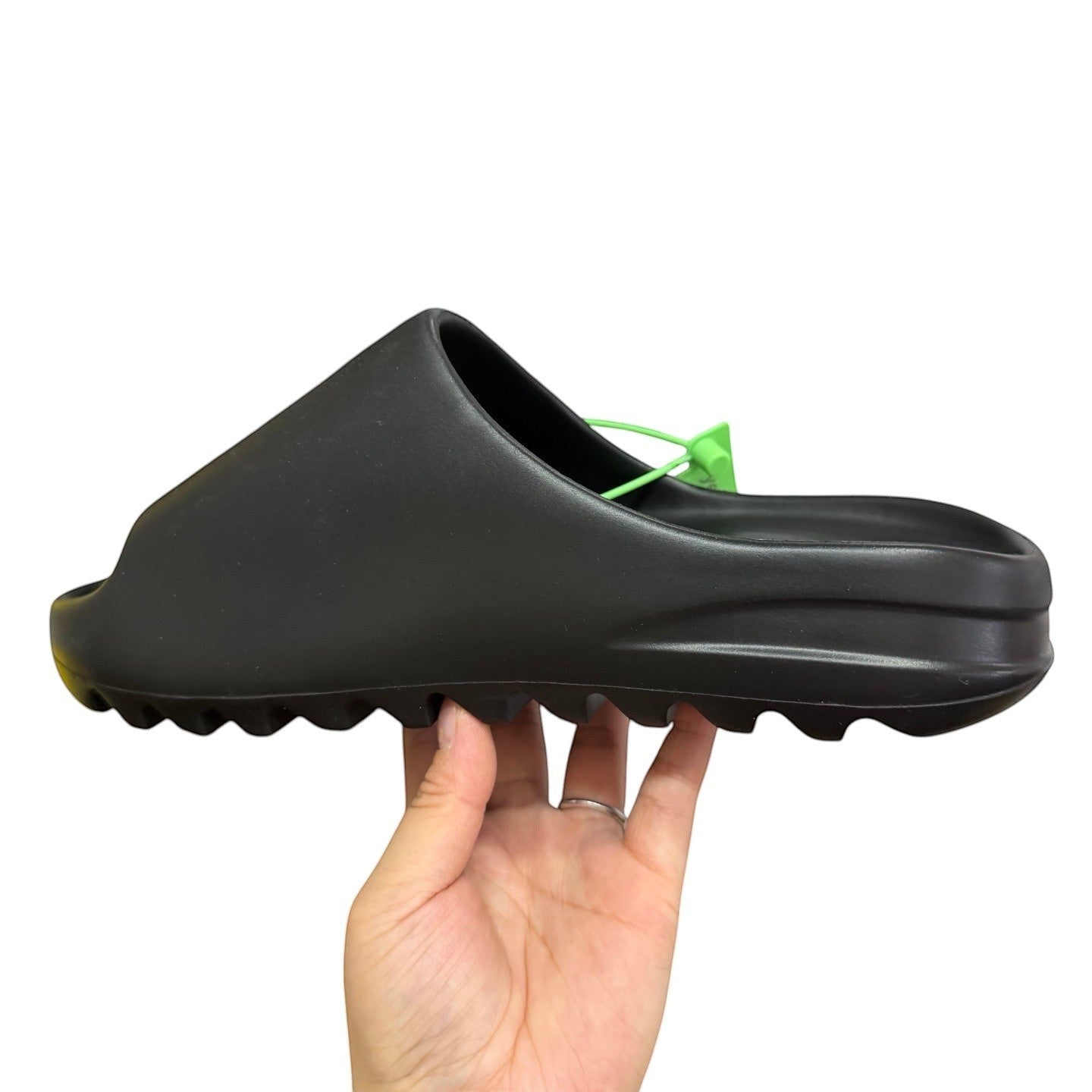 Luxury Chef black Yeezy slide sandal with contoured footbed and ridged sole. A green tag is attached.