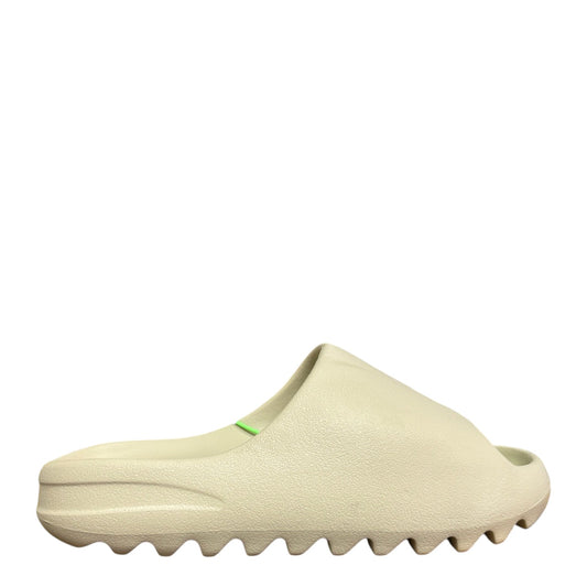 Luxury Chef YEEZY SLIDE in bone color, featuring a contoured footbed and serrated sole. Bright green accents on the strap.