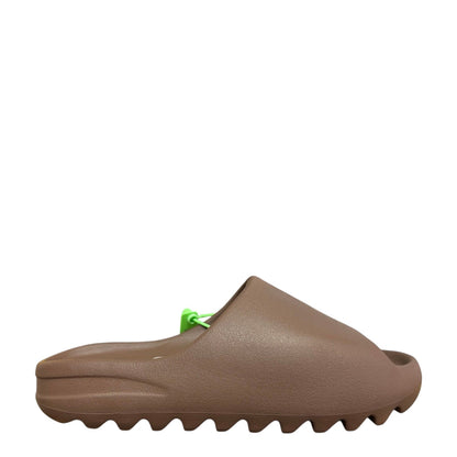 Luxury Chef YEEZY SLIDE in brown EVA foam with a serrated sole and bright green tag.