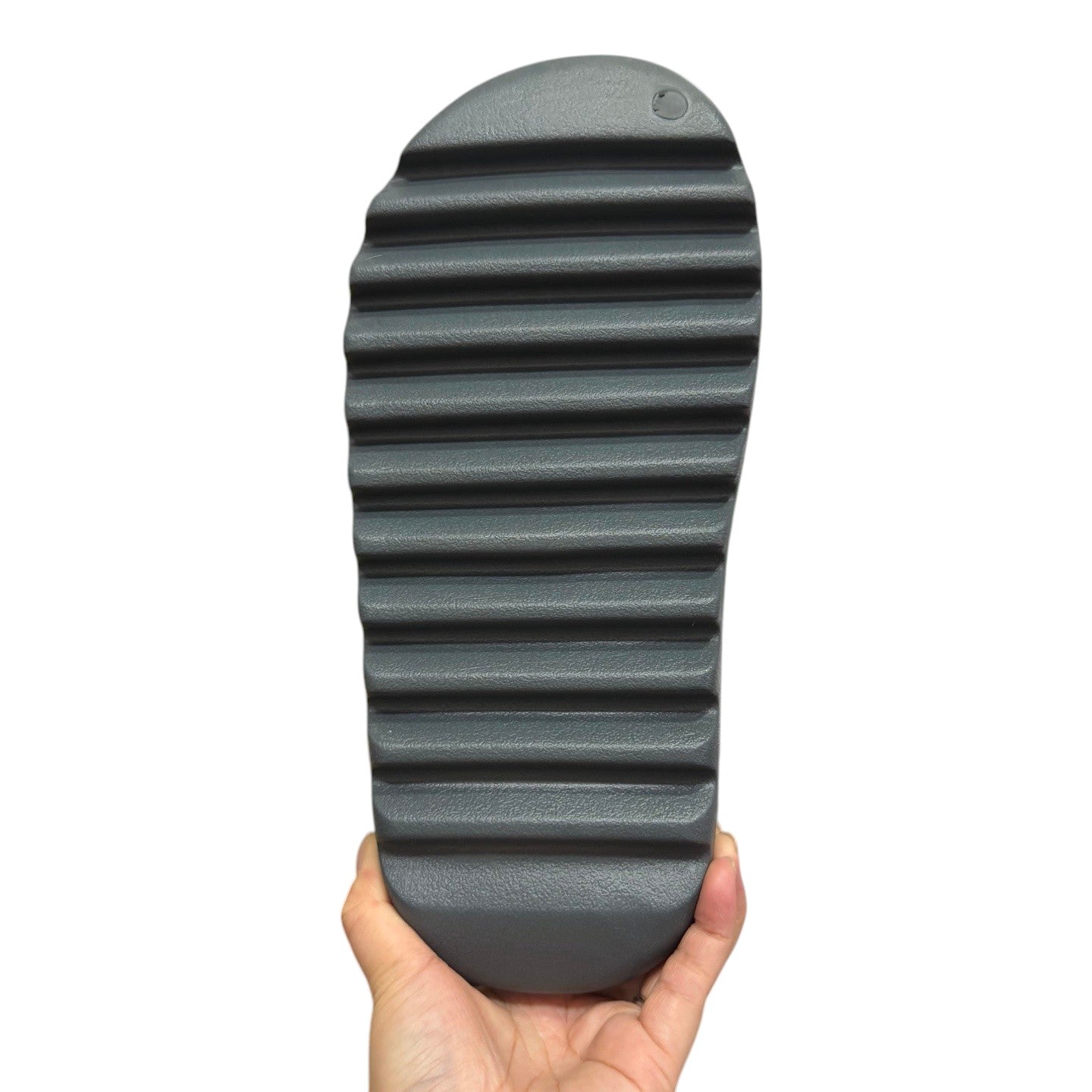 Luxury Chef YEEZY SLIDE, dark grey rubber slide with a ridged sole. Casual footwear.