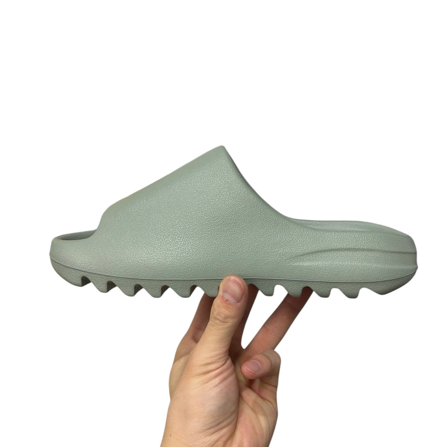 Luxury Chef YEEZY SLIDE in light green, made of EVA foam with a contoured footbed and jagged sole.