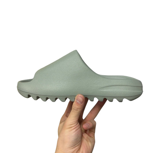 Luxury Chef YEEZY SLIDE in light green, made of EVA foam with a contoured footbed and jagged sole.
