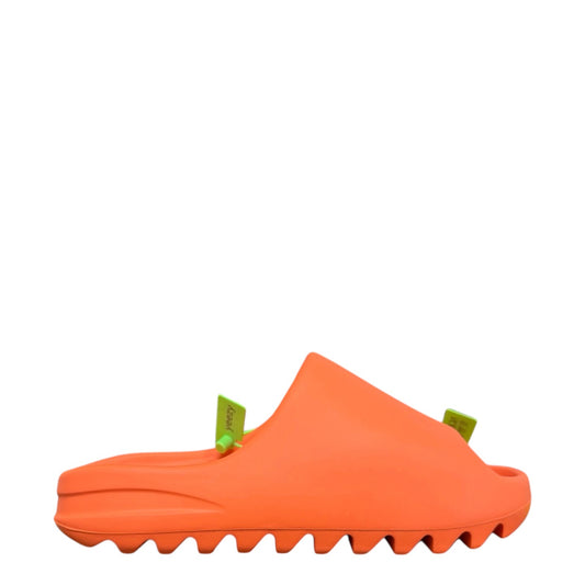 Luxury Chef YEEZY SLIDE in bright orange foam with green "yeezy" tags. Serrated sole detail.