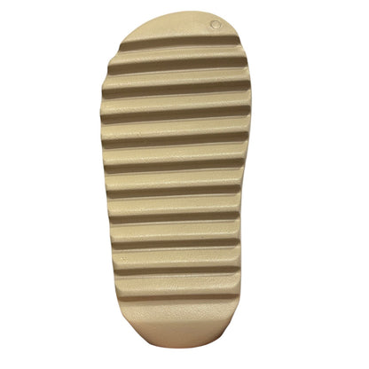 Luxury Chef YEEZY SLIDE in tan, featuring a contoured footbed and a thick, grooved sole for grip.