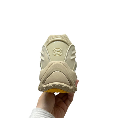 Luxury Chef NOCTA HOT STEP beige sneakers with yellow sole and G-TEK logo on heel.