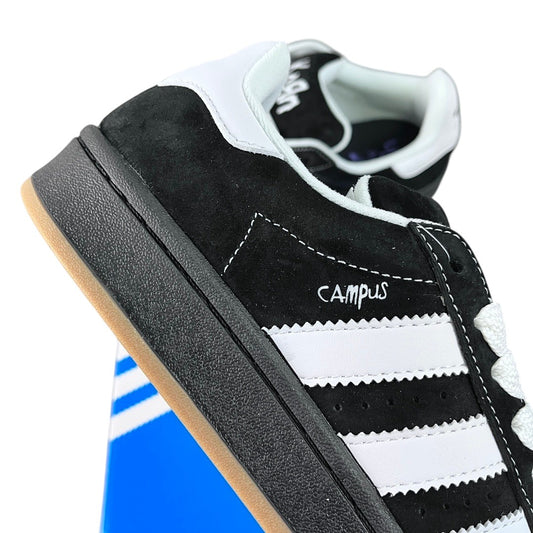 Luxury Chef Adidas Campus black suede sneakers with white stripes and gum sole.