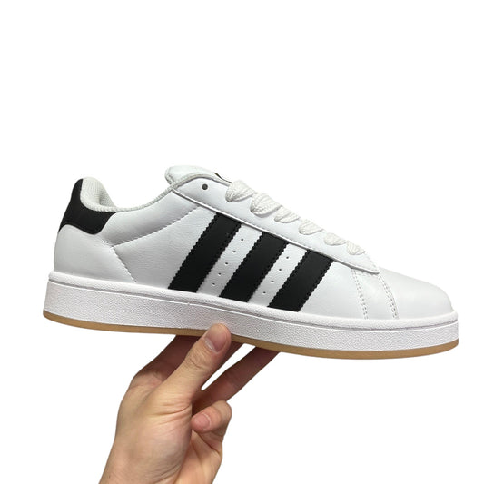 Luxury Chef Adidas Campus white leather sneakers with black stripes and gum sole.