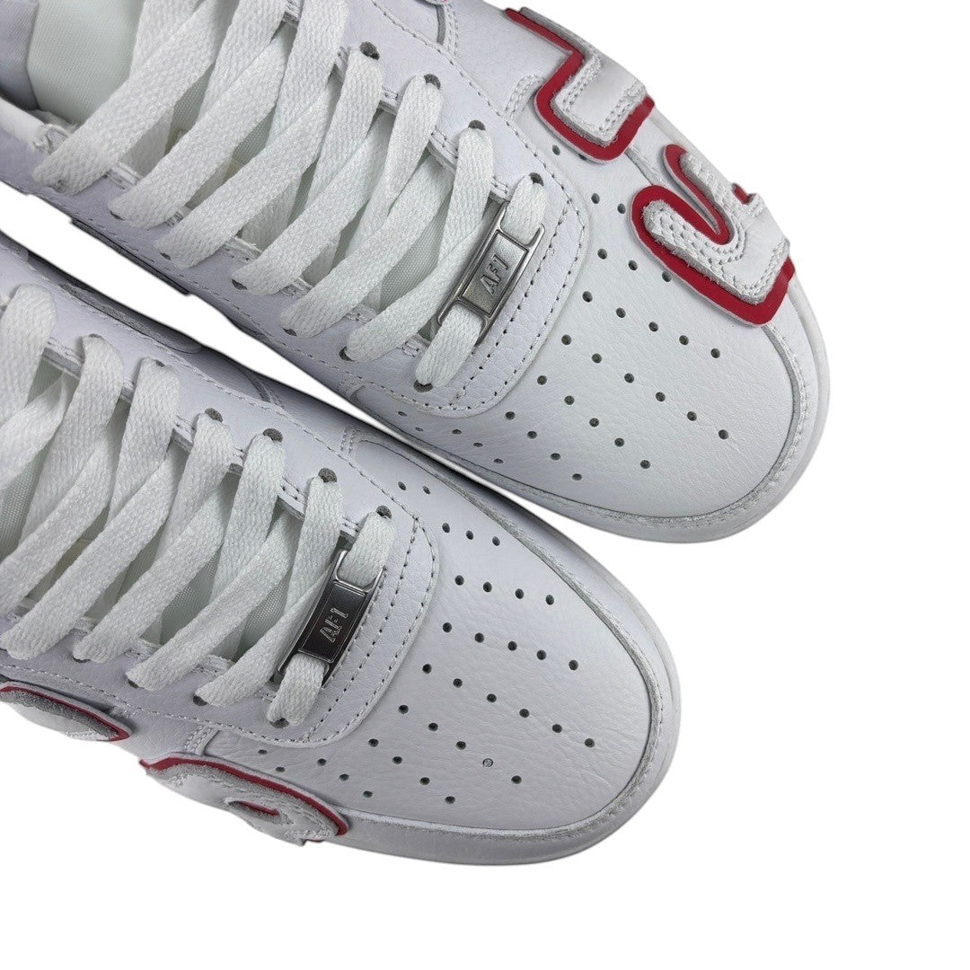 Luxury Chef white leather Air Force 1 CPFM sneakers with red accents and perforated toe boxes.