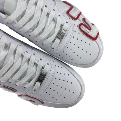 Luxury Chef white leather Air Force 1 CPFM sneakers with red accents and perforated toe boxes.