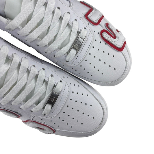 Luxury Chef white leather Air Force 1 CPFM sneakers with red accents and perforated toe boxes.