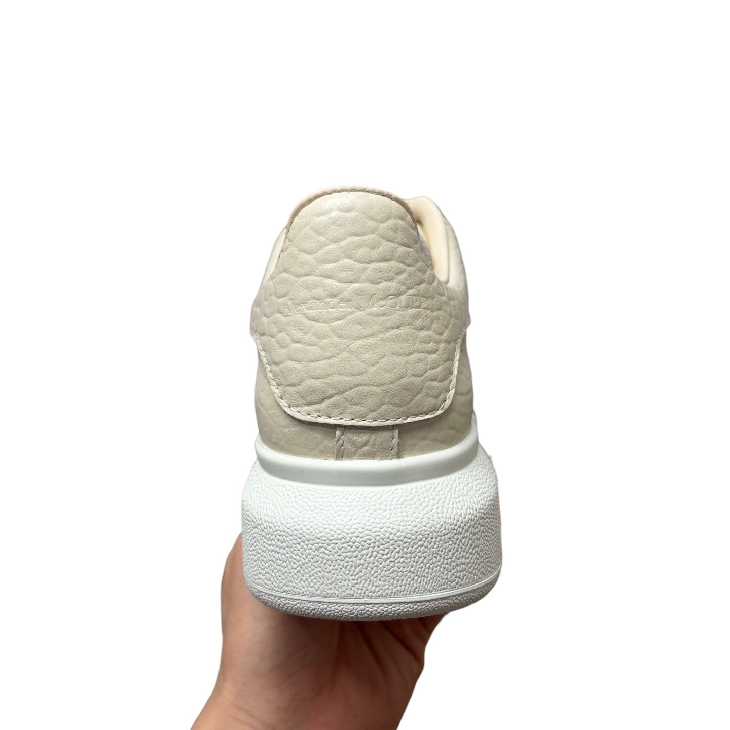 Luxury Chef Alexander McQueen cream textured leather sneakers with chunky white sole.