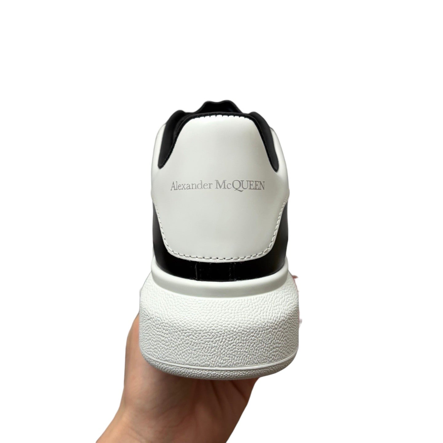 Luxury Chef Alexander McQueen white and black leather sneakers with chunky sole.