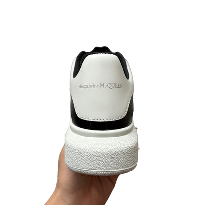 Luxury Chef Alexander McQueen white and black leather sneakers with chunky sole.