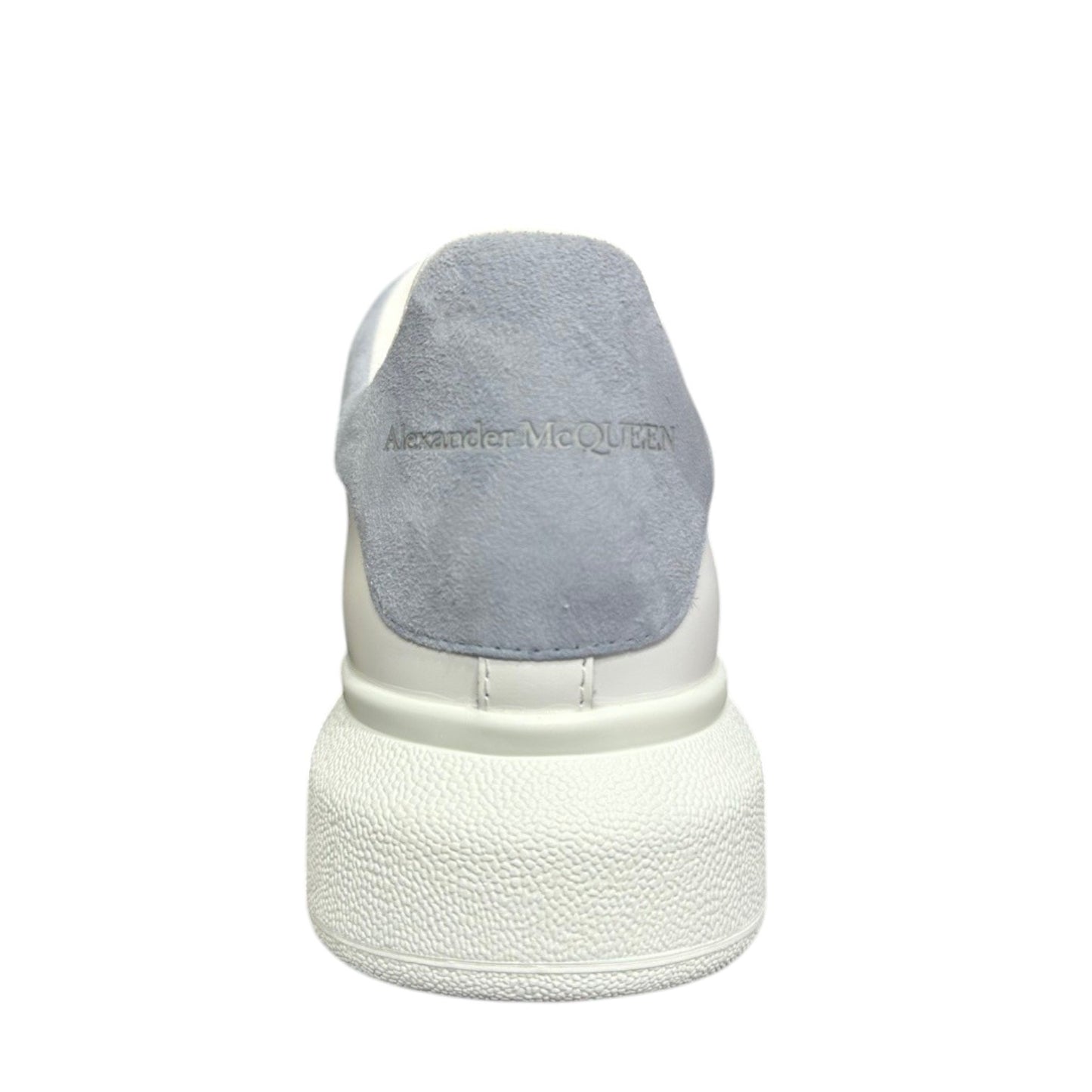 Luxury Chef Alexander McQueen white leather sneakers with light blue suede heel tab and embossed logo.