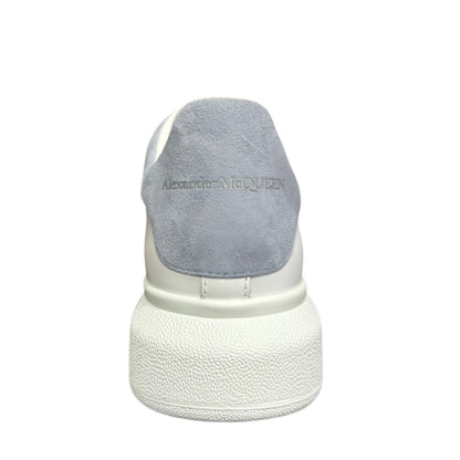 Luxury Chef Alexander McQueen white leather sneakers with light blue suede heel tab and embossed logo.