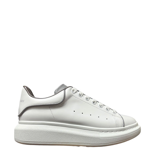 Luxury Chef Alexander McQueen white leather sneakers with a thick platform sole and grey trim.