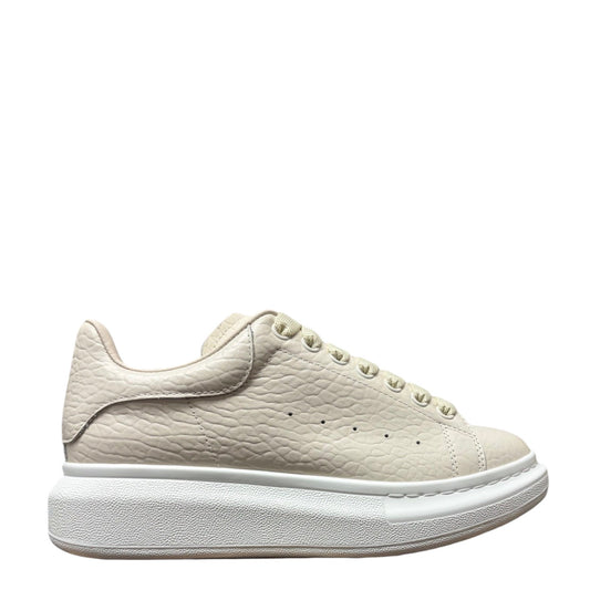 Luxury Chef Alexander McQueen oversized sole sneakers in textured off-white leather with a chunky white sole.