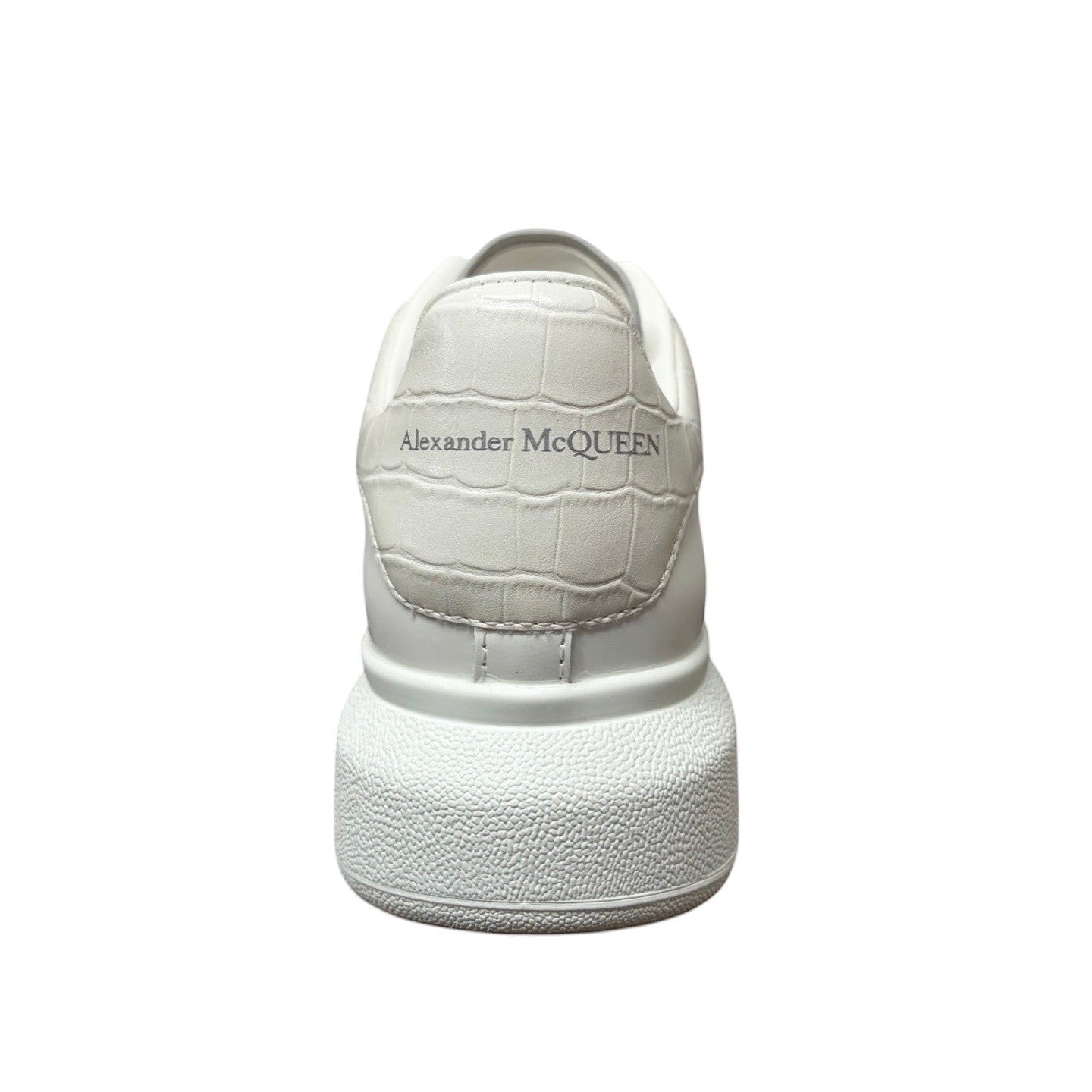 Luxury Chef white leather Alexander McQueen sneakers with embossed crocodile effect heel tab and chunky sole.