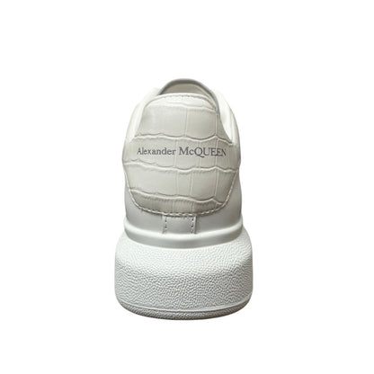 Luxury Chef white leather Alexander McQueen sneakers with embossed crocodile effect heel tab and chunky sole.