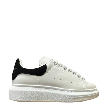 Luxury Chef Alexander McQueen white leather sneakers with black heel tab and chunky sole.