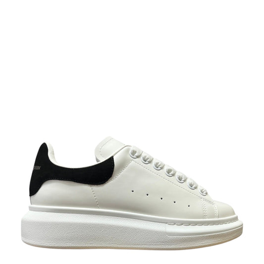 Luxury Chef Alexander McQueen white leather sneakers with black heel tab and chunky sole.