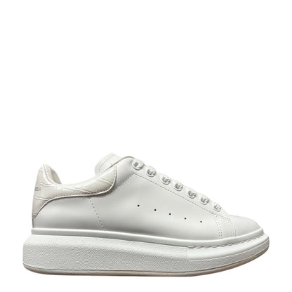 Luxury Chef Alexander McQueen white leather sneakers with crocodile embossed heel tab and chunky sole.