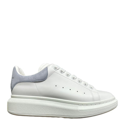 Luxury Chef Alexander McQueen white leather sneakers with light grey suede heel detail and chunky sole.