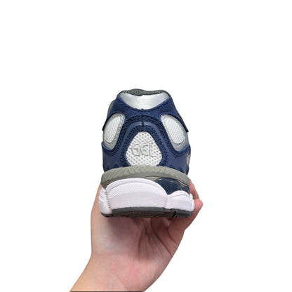 Luxury Chef ASICS GEL-NYC navy blue and silver athletic sneakers with white sole and GEL cushioning.