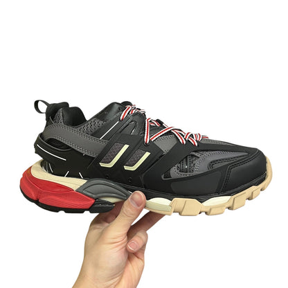 Luxury Chef Balenciaga Track sneakers in black, grey, red, and beige. Multi-material construction with dynamic lacing.