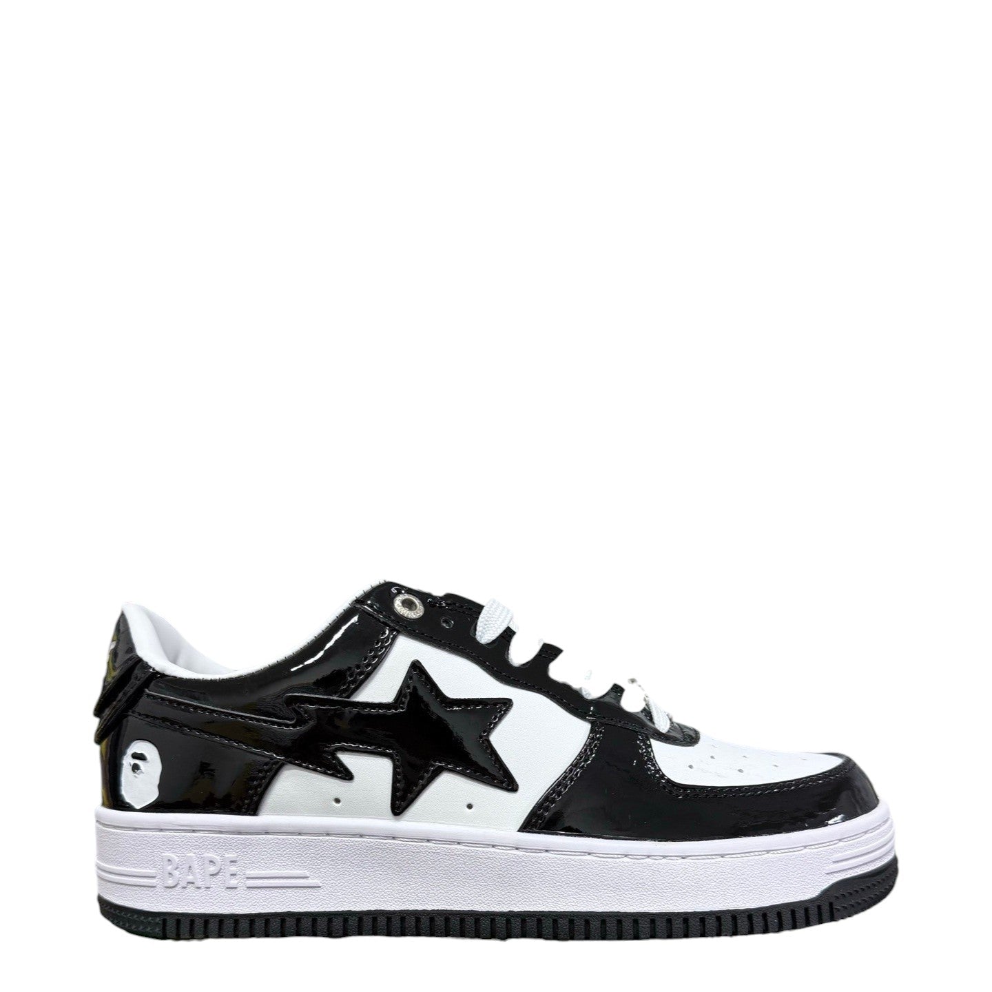 Luxury Chef BAPESTA sneakers in black and white patent leather with a star logo and ape head detail.