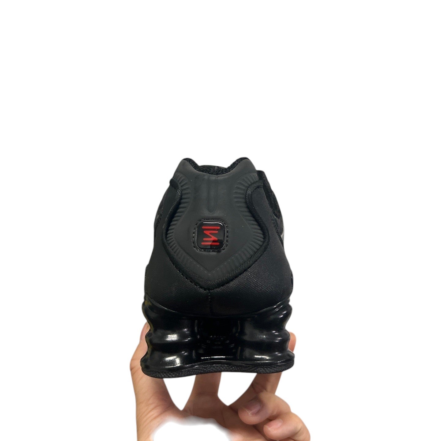 Luxury Chef black Nike Shox sneakers with distinctive coiled heel cushioning and red logo detail.
