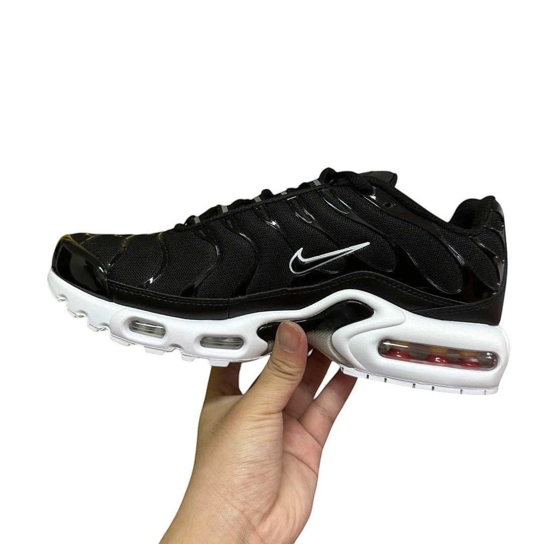 Luxury Chef black Nike TN sneakers with white accents and visible air cushioning. Mesh and patent leather details.